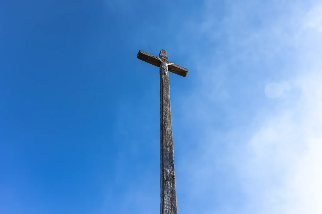 Imagen de una cruz con Jesús crucificado bajo un cielo despejado. Es común verlo durante la Semana Santa en México.